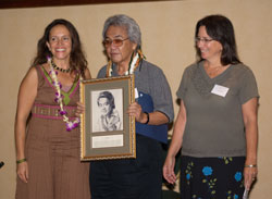 Donelle Sawyer and Nuni Walsh presenting Herb Ohta with his ʻUkulele Hall of Fame induction portrait, November 2006